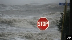 Isaac's winds and storm surge overcome a seawall and flood South Beach Boulevard, Waveland, Miss., Aug. 29, 2012.