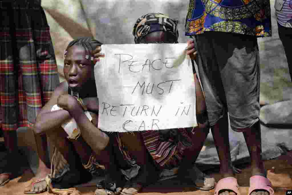 Children wait for the arrival of Pope Francis at a refugee camp in Bangui.