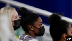 United States gymnast Simone Biles sits on the stands during the artistic gymnastics women's all-around final at the 2020 Summer Olympics, July 29, 2021, in Tokyo, Japan. 