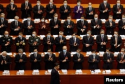 FILE - Chinese President Xi Jinping arrives for the opening session of the National People's Congress at the Great Hall of the People in Beijing, China, March 5, 2021.