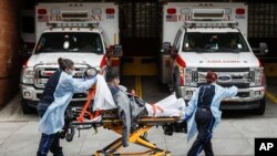 Patients are brought into Wyckoff Heights Medical Center by staff wearing personal protective gear due to COVID-19 concerns, Tuesday, April 7, 2020, in the Brooklyn borough of New York. 