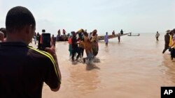 FILE; In a previous incident, rescue workers carry a victim of a boat accident in Wara Kebbi , Nigeria, Thursday, May 27, 2021. More than 100 people are missing and feared dead after a boat with more than 165 passengers, sank as it was traveling in Nigeria's northern Kebbi state,