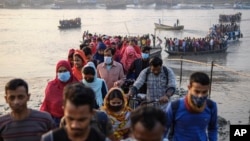 Workers walk to work at an export processing zone early in the morning after crossing the Mongla river in Mongla, Bangladesh, March 3, 2022. This Bangladeshi town stands alone to offer new life to thousands of climate migrants. (AP Photo/Mahmud Hossain Opu)