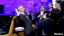 FILE - Michael Horn, President and CEO of Volkswagen America, reacts to being mobbed by the media after he apologized for the Volkswagen diesel scandal at the LA Auto Show in Los Angeles, California, Nov. 18, 2015. 