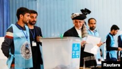 FILE - Afghan incumbent president and presidential candidate Ashraf Ghani arrives to cast his vote in Kabul, Afghanistan, Sept. 28, 2019. 