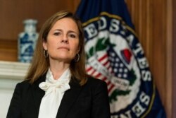 FILE - Supreme Court nominee Judge Amy Coney Barrett listens during a meeting on Capitol Hill, Oct. 1, 2020.