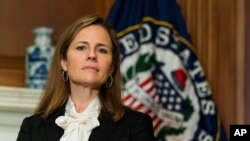 FILE - Supreme Court nominee Judge Amy Coney Barrett listens during a meeting on Capitol Hill, Oct. 1, 2020.