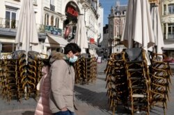 Stacked chairs are seen in front of a cafe in Lille, northern France, Oct. 12, 2020. Lille has been placed under maximum virus alert.