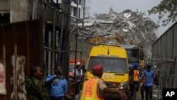 Rescue workers gather around an ambulance with a survivor found in the rubble of the collapsed 21-story apartment building under construction in Lagos, Nigeria, Nov. 2, 2021.