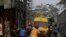 Rescue workers gather around an ambulance with a survivor found in the rubble of the collapsed 21-story apartment building under construction in Lagos, Nigeria, Nov. 2, 2021.