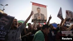 Members of the Muslim Brotherhood and supporters of deposed Egyptian President Mohamed Morsi shout slogans during a protest at Rabaa Adawiya Square, where they are camping, in Nasr City, east of Cairo, Aug. 7, 2013.