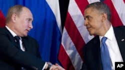 President Barack Obama shakes hands with Russian President Vladimir Putin, G20 Summit, Los Cabos, Mexico, June 18, 2012.