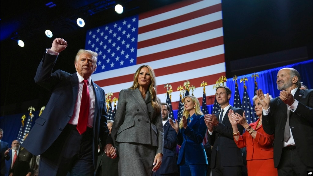 Former President Donald Trump gestures as he walks with former first lady Melania Trump at an election night watch party at the Palm Beach Convention Center, Wednesday, Nov. 6, 2024, in West Palm Beach, Fla. (AP Photo/Evan Vucci)