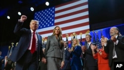 Former President Donald Trump gestures as he walks with former first lady Melania Trump at an election night watch party at the Palm Beach Convention Center, Wednesday, Nov. 6, 2024, in West Palm Beach, Fla. (AP Photo/Evan Vucci)