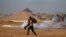 A wounded Palestinian is evacuated during a protest calling for lifting the Israeli blockade on Gaza and demanding the right to return to their homeland, at the Israel-Gaza border fence, in the southern Gaza Strip, Sept. 21, 2018.
