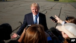 President Donald Trump speaks with reporters before boarding Air Force One at Morristown Municipal airport, Sept. 24, 2017, in Morristown, N.J. 