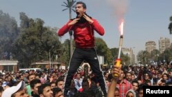 Students who are supporters of the Muslim Brotherhood and ousted President Mohamed Morsi shout slogans in front of Cairo University, March 26, 2014.