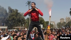 Students who are supporters of the Muslim Brotherhood and ousted President Mohamed Morsi shout slogans in front of Cairo University, March 26, 2014.