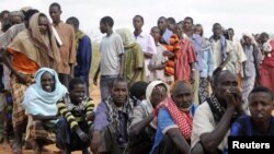 FILE - Somali refugees line up to wait for the reception center to open at Ifo settlement at Kenya's Dadaab Refugee Camp, situated northeast of the capital Nairobi near the Somali border, September 1, 2011. 