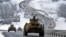 A convoy of Russian armored vehicles moves along a highway in Crimea, Jan. 18, 2022.