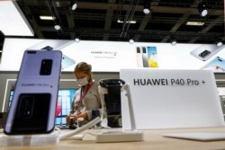 A visitor is seen at a Huawei P40 Pro+ stand at the IFA consumer technology fair in Berlin, Germany, Sept. 3, 2020.
