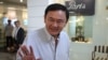 FILES - Thailand's former prime minister Thaksin Shinawatra waves as he walks out from a beauty salon in Bangkok on June 5, 2024.