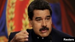 FILE - Venezuelan President Nicolas Maduro talks to reporters during a news conference at Miraflores Palace in Caracas, Aug. 22, 2017. 