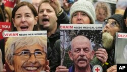 FILE — A person at left holds a poster of Vivian Silver as health professionals attend a demonstration in front of the International Committee of the Red Cross in London, Thursday, Nov. 9, 2023, calling for the releas of the hostages kidnapped from Israel on October 7. 