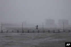 A sculpture of Poseidon stands in the ocean after the eye of Hurricane Milton passed off the coast of Progreso, Yucatan state, Mexico, Oct. 8, 2024.