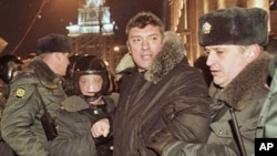 Riot police officers detain Russian opposition leader Boris Nemtsov during a rally in central Moscow, 31 Dec 2010