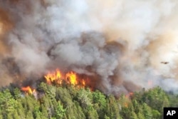 FILE - In this image released by the Ontario Ministry of Natural Resources and Forestry, the Sudbury 17 wildfire burns east of Mississagi Provincial Park near Elliot Lake, Ontario, on June 4, 2023.(Ontario Ministry of Natural Resources and Forestry/The Canadian Press via AP, File)