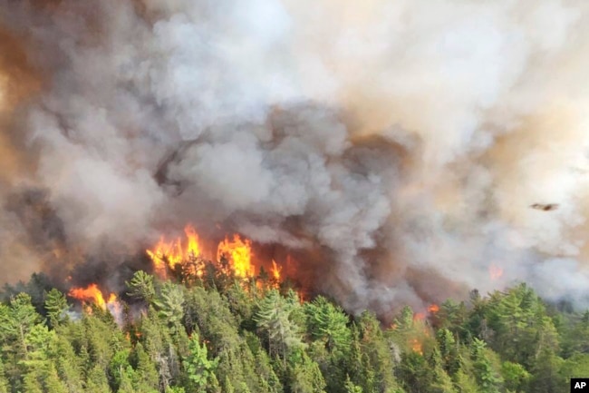 FILE - In this image released by the Ontario Ministry of Natural Resources and Forestry, the Sudbury 17 wildfire burns east of Mississagi Provincial Park near Elliot Lake, Ontario, on June 4, 2023.(Ontario Ministry of Natural Resources and Forestry/The Canadian Press via AP, File)