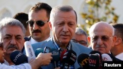 Turkey's President Tayyip Erdogan talks to media after the Eid al-Fitr prayers in Istanbul, June 25, 2017.