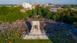 FILE - In this photo taken with a drone, a large group of protesters gather around the statue of Confederate General Robert E. Lee on Monument Avenue near downtown in Richmond, Virginia, June 2, 2020.