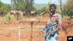 Woman at water tap