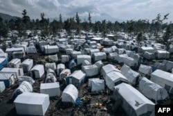 FILE - This aerial photograph, taken on October 2, 2023, shows the Rusayo IDP camp, home to tens of thousands of war-displaced people, located at the foot of the active Nyiragongo volcano, on the outskirts of Goma in the East of the Democratic Republic of Congo.