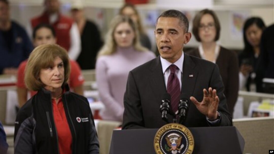 President Barack Obama, accompanied by American Red Cross President and CEO Gail J. McGovern, gestures while speaking during his visit to discuss superstorm Sandy, at the Disaster Operation Center of the Red Cross National Headquarters in Washington, Oct.