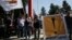 Anti-bailout protesters hold a banner and a Cypriot flag during a student parade marking Greece's Independence Day, in Nicosia, Cyprus, March 25, 2013.