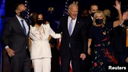 President-elect Joe Biden and his wife Jill, and Vice President-elect Kamala Harris and her husband Doug, celebrate after the news media announced that Biden has won the 2020 U.S. presidential election November 7, 2020. (REUTERS/Jim Bourg)