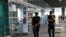 FILE - Police officers patrol at Turkey's largest airport, Istanbul Ataturk, June 29, 2016. Two men were detained after a police pursuit at the airport Saturday.