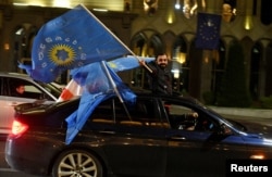 Supporters of the Georgian Dream enactment      waves the party's flags from a car   aft  the announcement of exit canvass  results successful  parliamentary elections, successful  Tbilisi, Georgia Oct. 26, 2024.