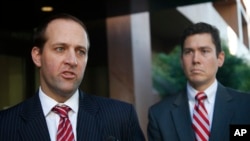 Assistant U.S. Attorneys Mark Pletcher, left, and Robert Huie, talk outside the federal courthouse, about the guilty plea of Leonard Francis, known in military circles as Fat Leonard, on bribery charges involving U.S. Navy officials Thursday, Jan. 15, 201