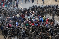 La caravana de migrantes choca con la barrera de policías y soldados guatemaltecos en Vado Hondo, Guatemala, el 17 de enero de 2021.