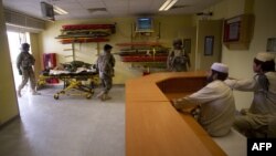 A wounded Afghan man (2nd L) from Afghan National Police (ANP) is brought inside after he was airlifted by the Medevac of the 159th Brigade Task Force Thunder on August 24, 2011 to a Kandahar hospital. 