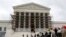Visitors to the Supreme Court are pictured in the rain in Washington, Oct. 7, 2013. 