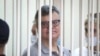 FILE - Viktar Babaryka, a former presidential hopeful, stands inside a defendants’ cage during his trial in Minsk, Belarus, on July 6, 2021. 