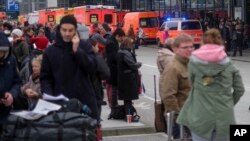 Travelers wait outside the Hamburg airport, Feb. 12, 2017 after after several people were injured by an unknown toxic that likely spread through the airports’ air conditioning system.