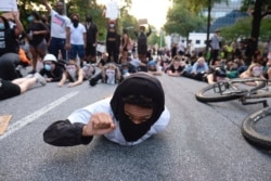 Protesters lie on a street during a demonstration June 1, 2020, in Atlanta over the death of George Floyd, who died May 25 in Minneapolis.