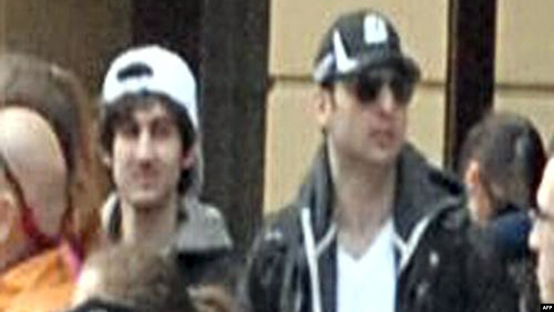  Images released by Federal Bureau of Investigation (FBI) shows "Suspect 2" (L-white cap) and "Suspect 1" (R-black cap) in the crowd before the blast at the Boston Marathon on April 15, 2013.