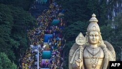 Hindu devotees climb the 272 steps to the Batu Caves temple to make offerings during the Thaipusam festival at Batu Caves on the outskirts of Kuala Lumpur, Malaysia.